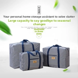 Three-piece set of grey striped travel storage bags with dark blue handles and zipper