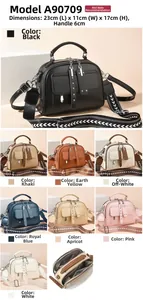 Detail view of stylish PU leather handbag with wide pattern strap and multi-pocket design
