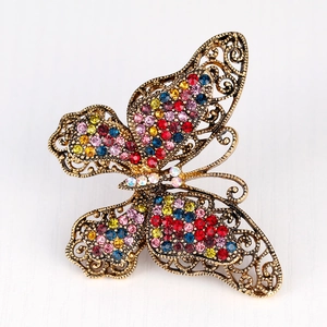 Vintage butterfly brooch with multicolored rhinestones and bronze openwork design