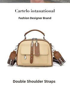 Detail of beige Boston bag showing brown leather handles and woven arrow strap