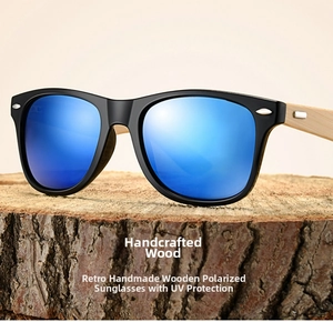 Macro view of blue mirrored lenses and natural wood grain temples on sunglasses
