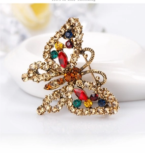 Detailed view of vintage butterfly brooch with colorful rhinestones and gold-tone metal