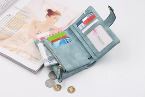 Detail of light blue tri-fold wallet showing card slots, photo window and coin pocket
