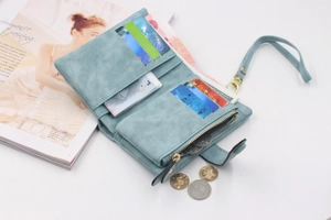 Detail view of light blue matte wallet with multiple card slots and zipper pocket