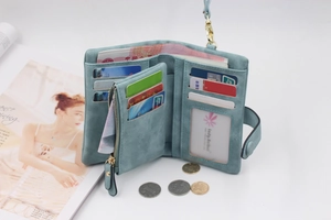 Detail view of the open tri-fold light blue matte PU leather wallet showing card slots