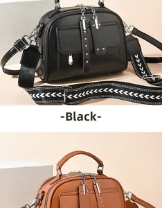Detail of vintage PU crossbody bags with dual zippers and patterned wide shoulder straps