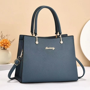 Classic navy blue lychee textured leather handbag with dual handles and gold accents
