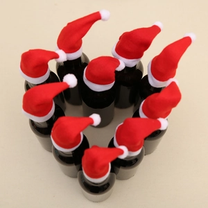 Mini Christmas hats set arranged in a heart shape on glass bottles for holiday decor