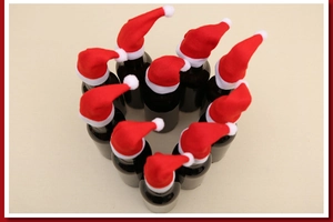 Creative heart arrangement of mini Christmas hats on small bottles for festive decoration