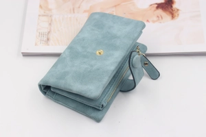 Close-up of light blue matte PU leather wallet with golden snap and wristlet strap