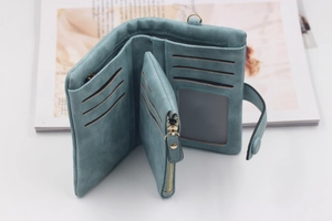 Detail view of teal blue matte PU leather wallet featuring card slots and coin pocket