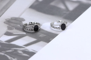 Detail of S925 silver ring featuring black onyx inlay and woven chain band design