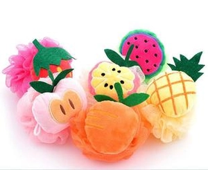 Detailed view of colorful fruit-themed mesh shower sponges including strawberry and pineapple