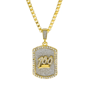 Macro detail of gold-plated 100 emoji pendant featuring sparkling glitter and rhinestones