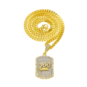 Detailed view of gold box chain and iced-out 100 pendant necklace with cubic zirconia