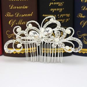 Macro detail of silver bridal hair comb with shimmering rhinestones and white pearls