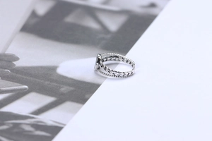 Macro detail of S925 sterling silver ring with black agate and braided band design