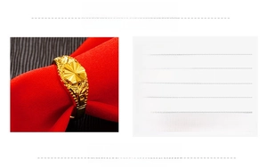 Detailed close-up of 24k gold plated brass ring with floral engraving and open design