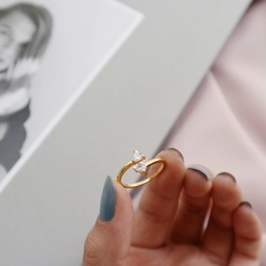 Macro shot of 18K gold-plated S925 silver ring featuring two pear-cut cubic zirconia stones