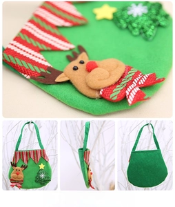 Detail of green felt Christmas elk gift bag featuring sequined tree and wavy red trim