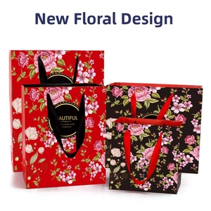 Floral gift bags with gold ring detail and silk handles in four graduated sizes