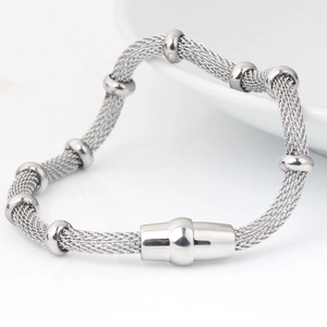 Detail of silver mesh chain bracelet with spherical beads and magnetic clasp closure