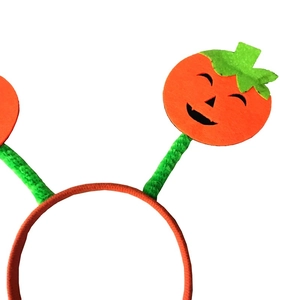 Halloween pumpkin headband with smiling face felt design on green plush spring wire