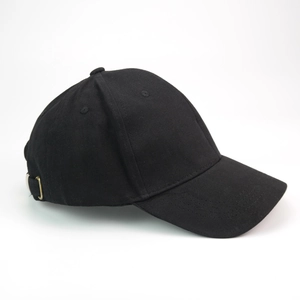 Detail shot of a black cotton baseball cap with a metal adjustable side buckle