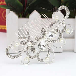 Close-up of bridal flower hair comb with sparkling crystals and elegant white pearls