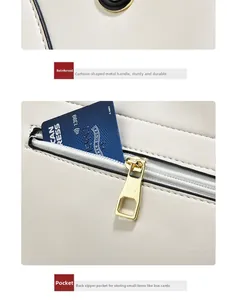 Detail of beige tote bag showing gold-tone hardware handle and hidden back zipper pocket