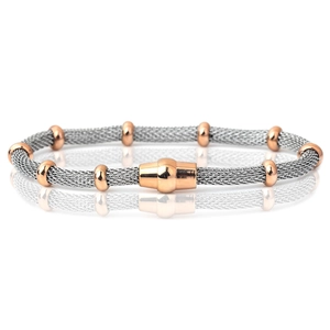 Macro detail of silver mesh chain bracelet with rose gold beads and magnetic clasp