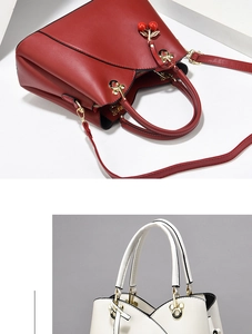 Detail of red and cream handbags with V-cut edges and cherry metal pendants