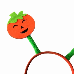 Halloween headband featuring an orange smiley pumpkin with green leaves on a white background