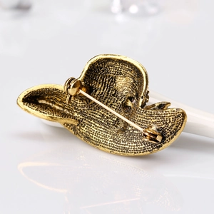 Antique gold cowboy hat brooch with rhinestone details and secure pin backing