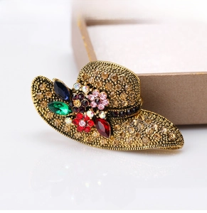Detail of vintage gold sun hat brooch with amber crystals and multicolored gemstones