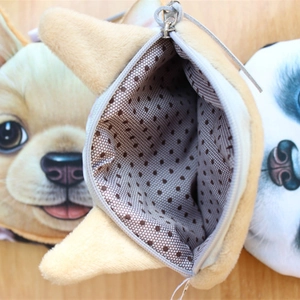 Plush animal head coin purse with zipper closure and spacious interior on wood surface