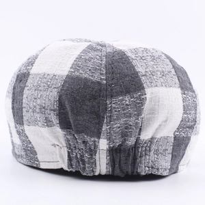 Rear view of black and white checkered beret cap with adjustable elastic band detail