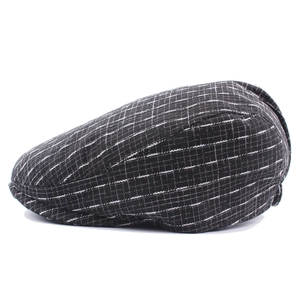 British style black and white checkered ivy cap with flat top and slightly curved brim
