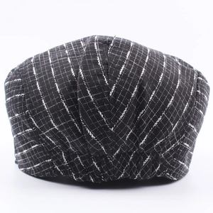 Classic black and white checkered ivy cap featuring a textured woven cotton-linen fabric