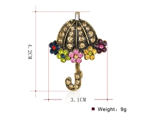 Detailed view of vintage umbrella brooch with colorful rhinestones and dimensions 4.2cm by 3.1cm