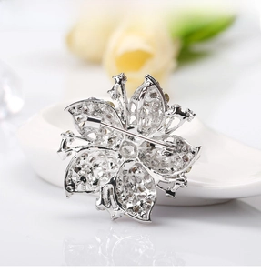Detailed back view of a silver floral crystal brooch with high-quality metal finish