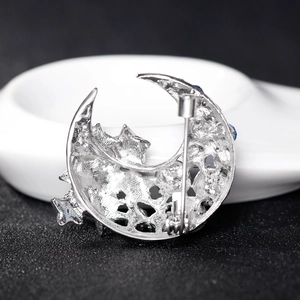 Rear view of silver alloy star and moon brooch showing secure safety pin clasp