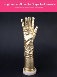 Macro shot of gold metallic faux leather long opera gloves for costume performances