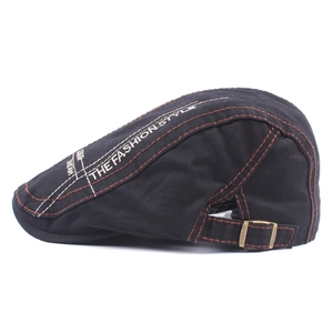 Black canvas beret with embroidered letters and contrast stitching for men outdoors