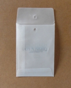 Detail of semi-transparent frosted packaging bag with hanging hole and Japanese text