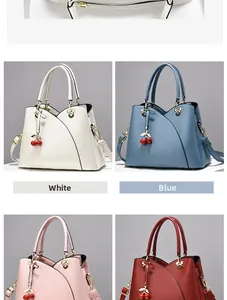 Detail view of stylish tote bags with Mickey-shaped metal rings and cherry charms
