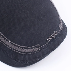 Black cotton newsboy cap for men featuring a metallic Style emblem and contrast stitching