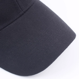 Close-up of a black cotton baseball cap showing detailed brim stitching and twill fabric