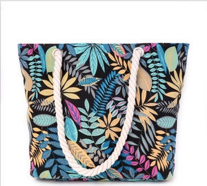 Minimalist canvas tote bag with colorful leaf patterns and white rope handles