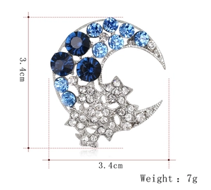 Detailed view of silver moon and star brooch with blue rhinestones, size 3.4cm by 3.4cm
